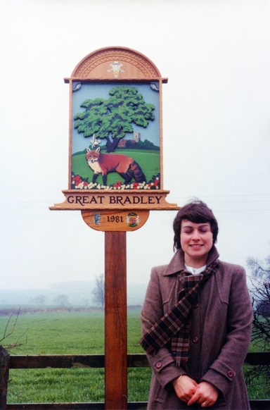 Wendy MANSFIELD in front of first village sign