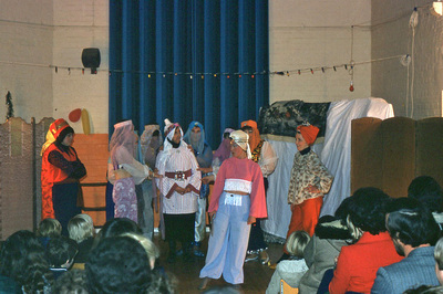 actors in a circle in village hall