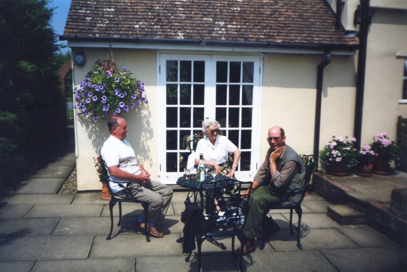 3 people sat round outdoor table
