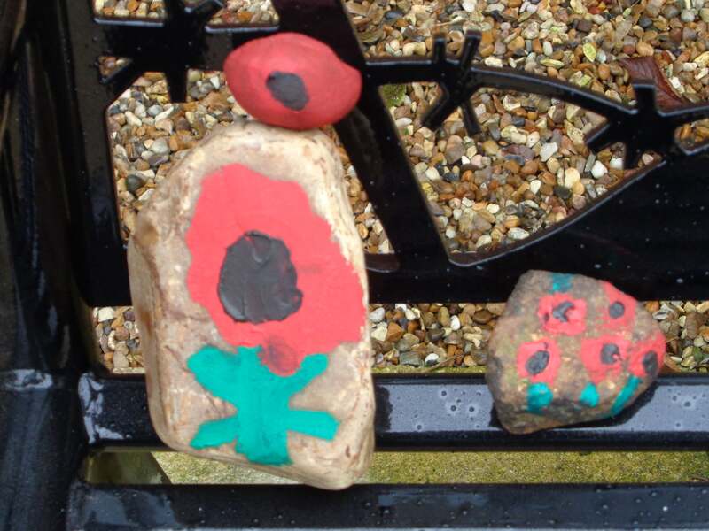 poppies painted on pebbles