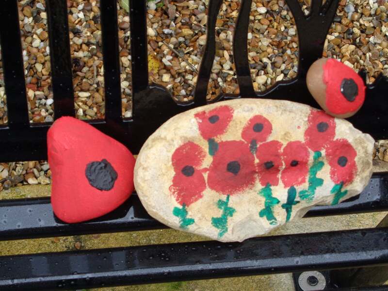 poppies painted on pebbles