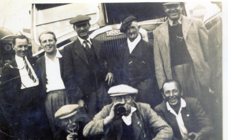 group of men in front of bus